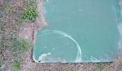 Lawn mower damage to treatment lid which was installed too low in the ground